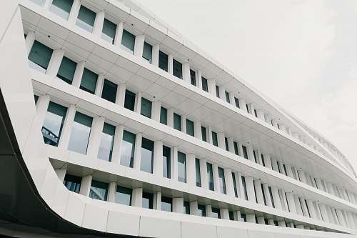architecture white concrete building under cloudy sky during daytime grey