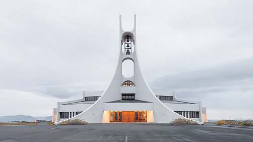 architecture white concrete building under white clouds iceland
