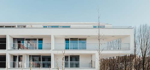 housing white painted building under blue sky house