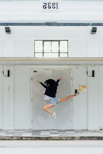 woman woman jumping in front of door jump