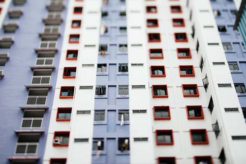 housing worm's eye view of white and gray building during daytime urban