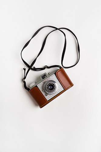 electronics brown and gray SLR camera on white surface lawrenceville