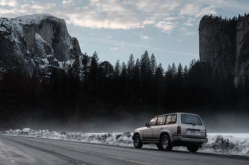 automobile gray sport utility vehicle on road road