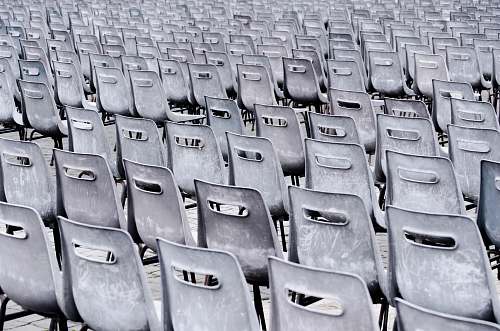 grey gray chairs lined up on pavement italy