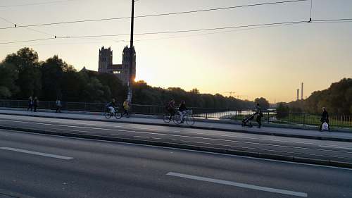 road three person riding on bike beside the asphalt road at daytime germany
