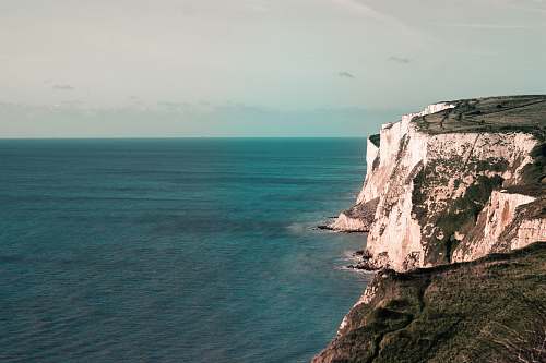 outdoors body of water beside cliff white cliffs of dover