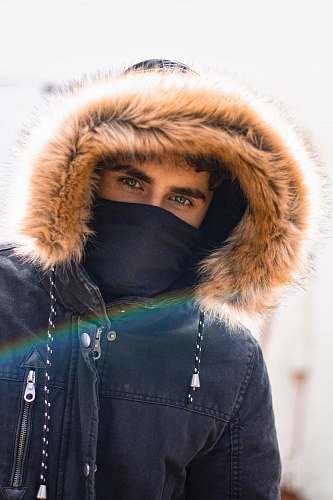 apparel selective focus photography of man wearing parka hoodie hood