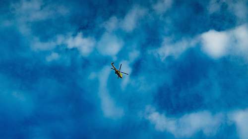 blue green and black helicopter clouds
