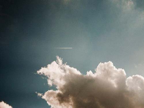 sky photo of contrail during cloudy daytime clouds