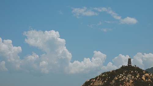 nature white clouds over black pagoda during daytime sky