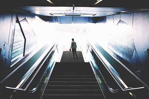 germany man standing on escalator solitude