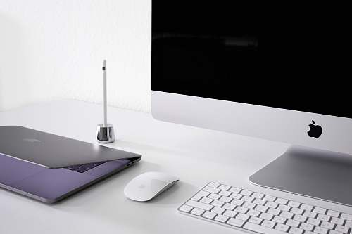 laptop silver iMac, keyboard, and mouse desk