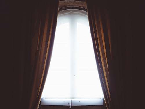 window clear glass window and brown curtain panel white