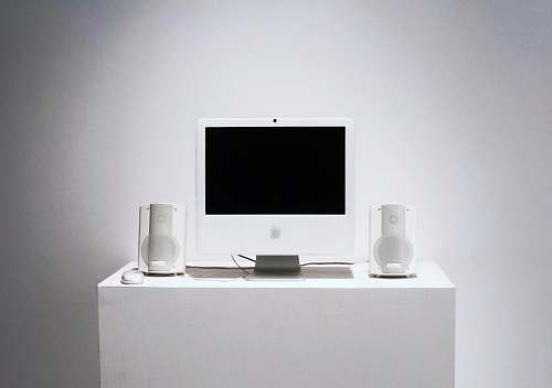 screen Apple Studio Display monitor on white table furniture