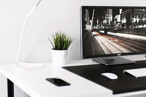 indoors white plant pot beside desk lamp interior design