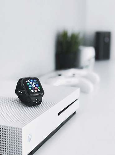wristwatch black aluminum case Apple Watch on white Xbox One console computer