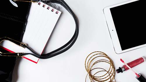text silver iPad beside liquid lipstick phone