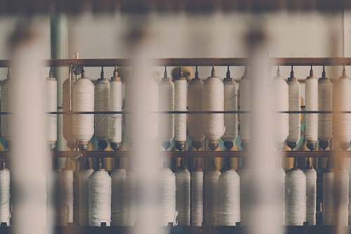 textile photography of white treadle on brown wooden rack cotton