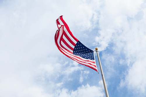 clouds flag of USA with flag pole emblem
