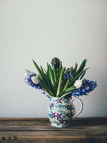 pot flowers on white floral vase on table plant