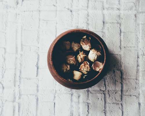 brick round brown wooden bowl on white brick bowl