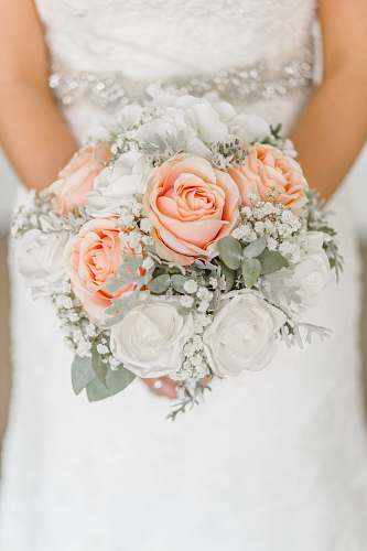 wedding woman holding white and pink rose flower bouquet rose