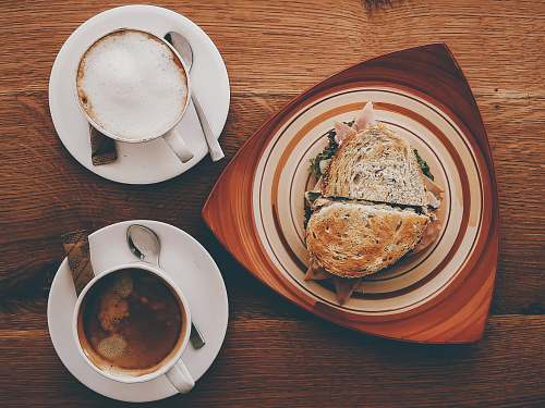 meal ham sandwich on plate near cappuccino on mug and coffee breakfast