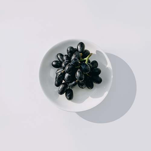 grapes java plum on white bowl fruit
