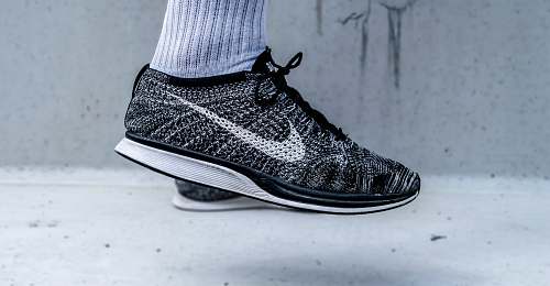 shoe unpaired black-and-gray Nike flynit racer shoes