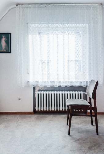 chair brown chair beside white radiator heater bench