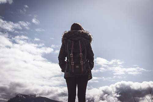 girl woman looking at clouds under blue sky during daytime cloud