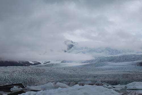 snow frozen hill during cloudy day glacier