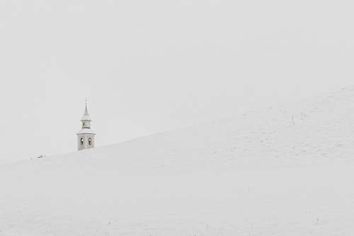 black-and-white gray concrete tower on pile of snow beacon