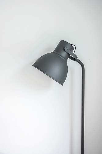 light gray desk lamp near white wall interior