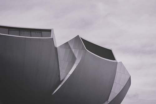 curve grey and white architectural building under daytime sky ] line