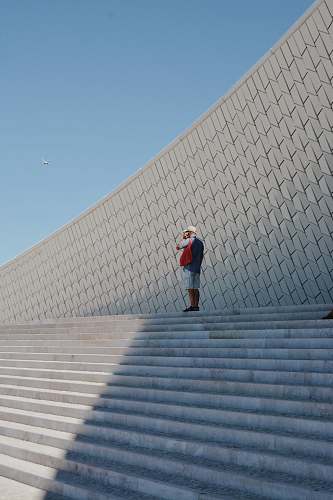 maat man standing near the stairs lisboa