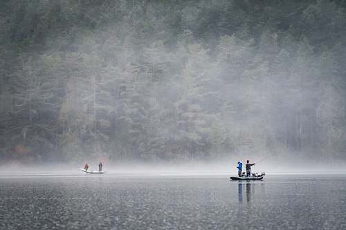 fog people on boat fishing near foggy forest lake campbell