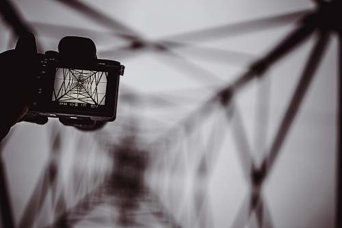 camera person holding DSLR camera capturing bridge viewfinder