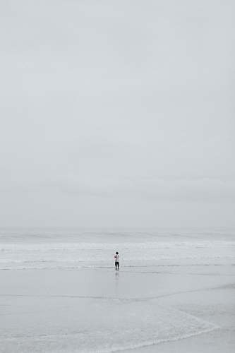 beach person in middle of seashore ocean