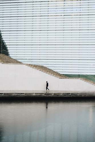 berlin person walking beside concrete staircase wall