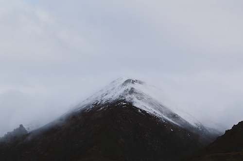 mountain snow mountain summit under clouds peak