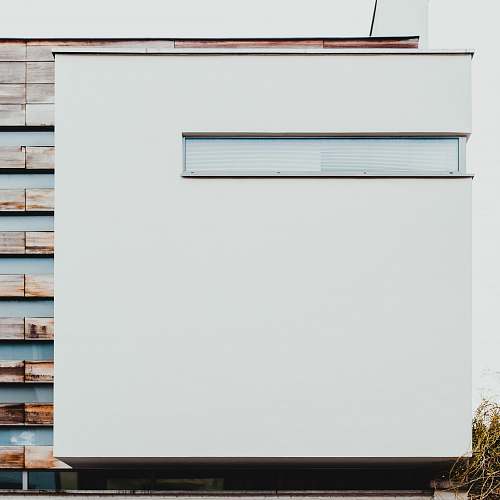 letterbox white and brown concrete building during daytime mailbox