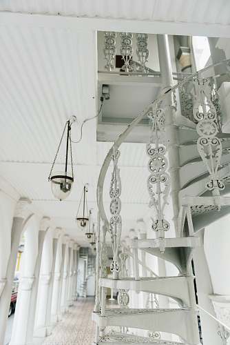 staircase white spiral stairs near pendant lamp white