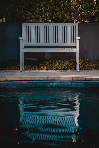 furniture white wooden bench near outdoor pool bench