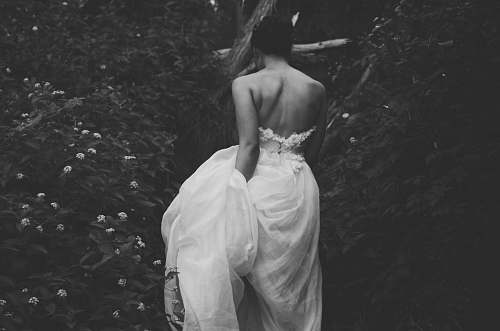 black-and-white woman wearing gown between flowers person