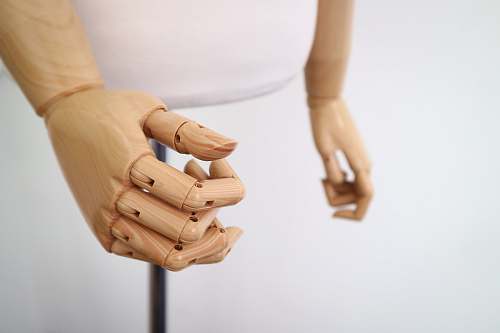 wooden shallow focus photography of brown wooden puppet model