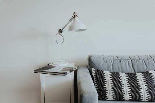 interior white desk lamp near gray fabric couch sofa