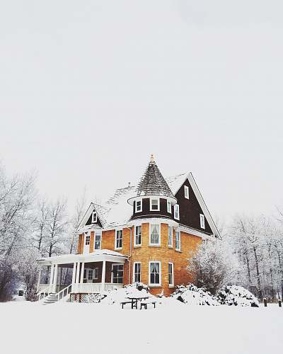 building orange and gray concrete house surround by snow home