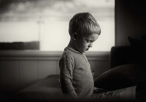 person boy wearing gray sweaters couch