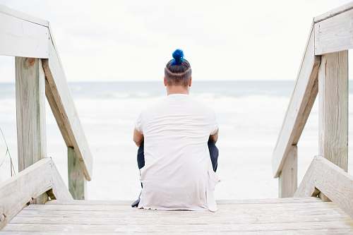 person man sitting on wooden staircase people